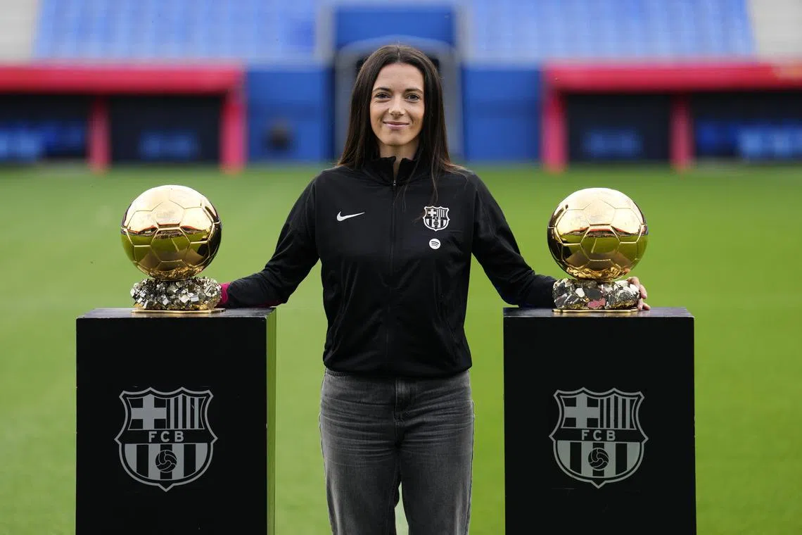 Barcelona midfielder Aitana Bonmati poses with her Ballon d'Or trophies before addressing the media at the Johan Cruyff stadium in Barcelona.