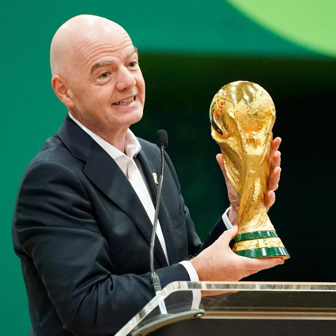 Jun 1, 2026; Dallas, Texas, USA; FIFA President Gianni Infantino holds the World Cup trophy while he speaks during the grand opening of the 2026 FIFA World Cup international broadcast center at Kay Bailey Hutchison Convention Center. Mandatory Credit: Raymond Carlin III-Imagn Images