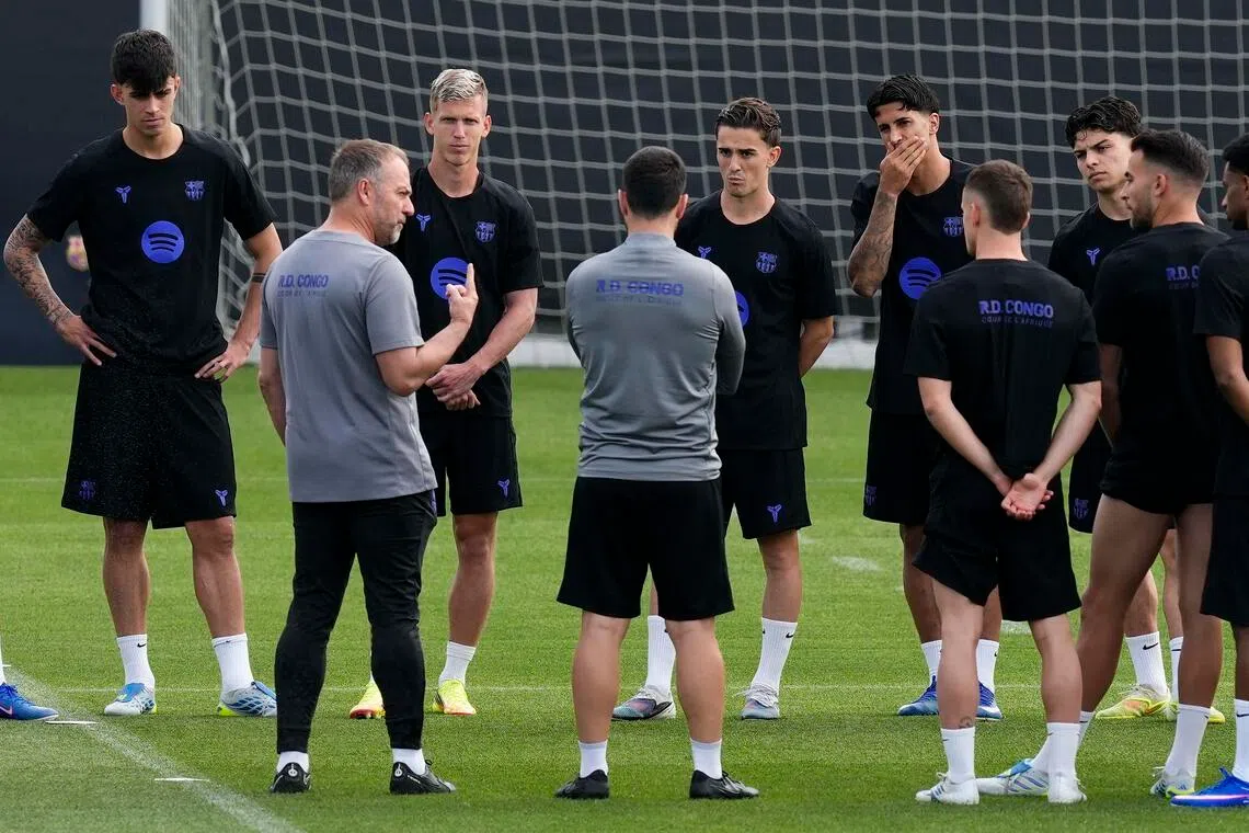 Barcelona coach Hansi Flick leads the team's training session at Joan Gamper Sports City in Barcelona.