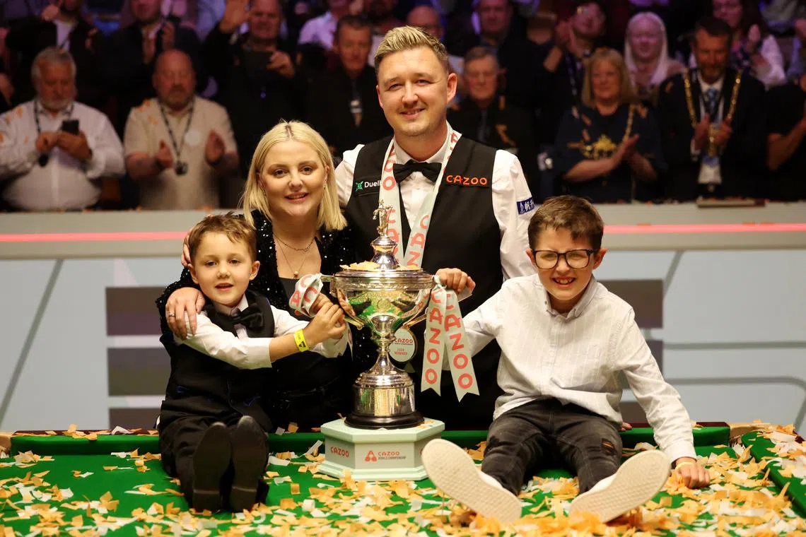 Snooker - World Snooker Championship - The Crucible Theatre, Sheffield, Britain - May 6, 2024 England's Kyren Wilson celebrates winning his final match against Wales' Jak Jones with his family and the trophy Action Images via Reuters/Andrew Boyers