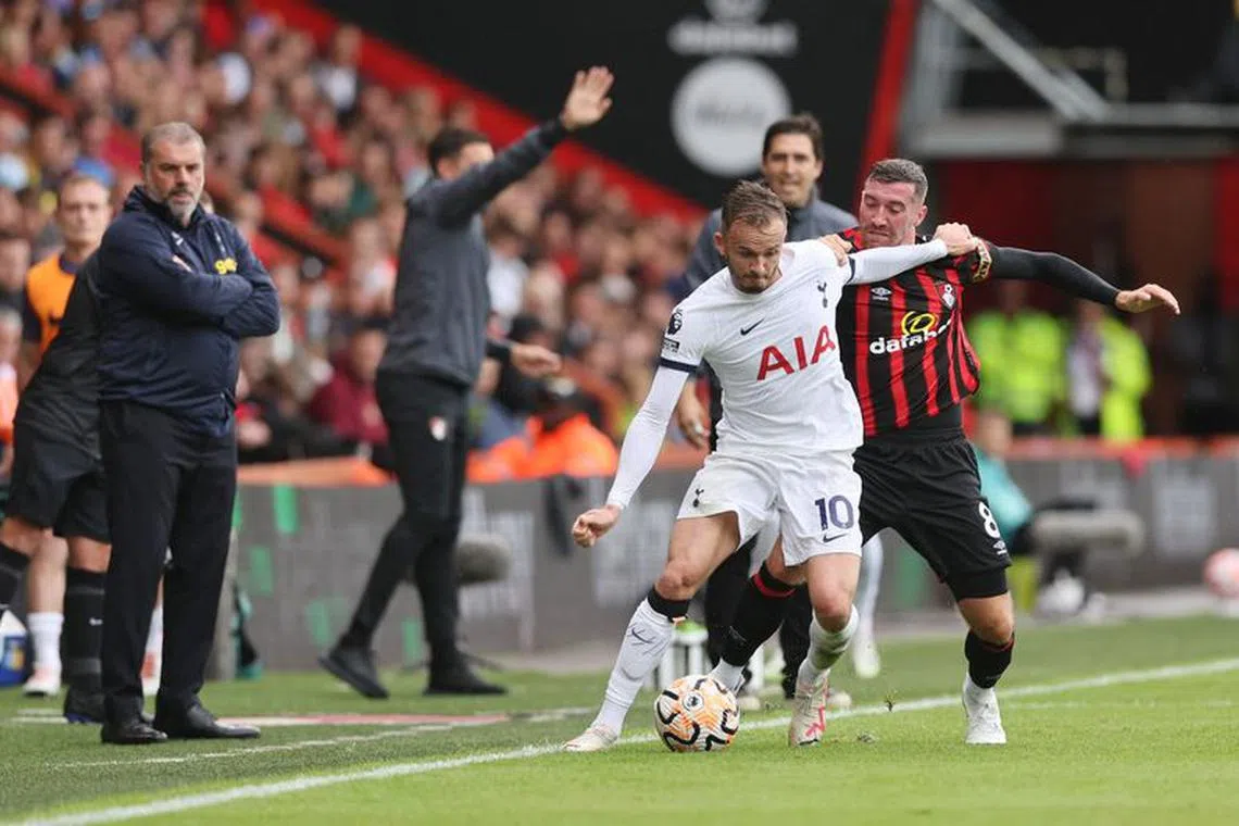 Soccer Football - Premier League - AFC Bournemouth v Tottenham Hotspur - Vitality Stadium, Bournemouth, Britain - August 26, 2023 Tottenham Hotspur's James Maddison in action with AFC Bournemouth's Joe Rothwell as Tottenham Hotspur manager Ange Postecoglou looks on REUTERS/David Klein