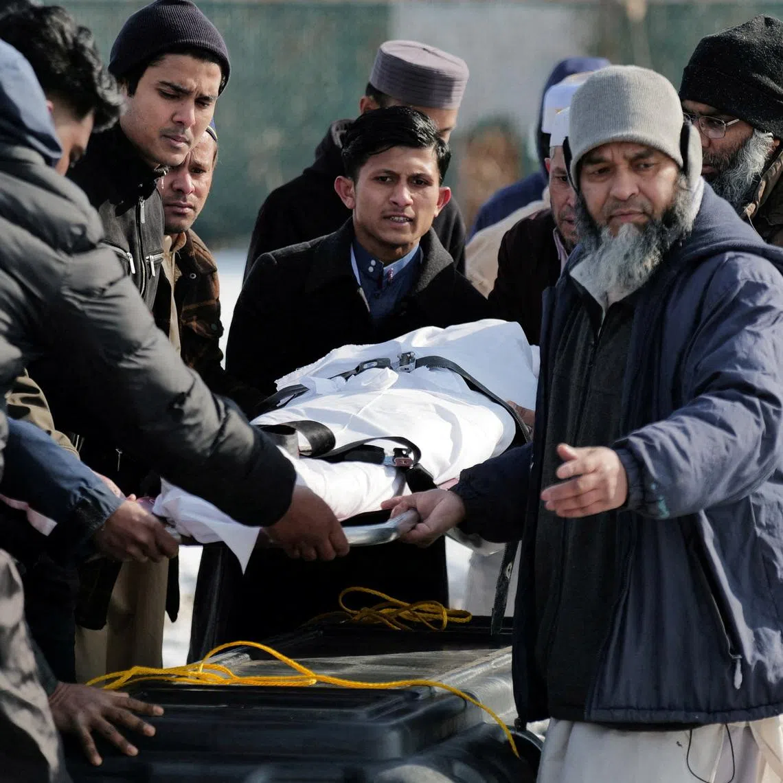 FILE PHOTO: Community members and loved ones carry the body of Nurul Amin Shah Alam, a nearly blind refugee from Myanmar who was missing since his release from a jail into the custody of the U.S. Border Patrol, and who was later found dead, during his funeral service, in Buffalo, New York, U.S., February 26, 2026. REUTERS/Craig Ruttle/File Photo
