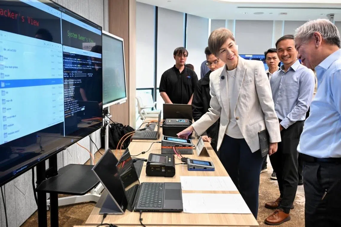 MDDI Minister Josephine Teo (third from left) and CSA chief executive David Koh (left) viewing the technical demonstration at an engagement event for cyber defenders on Feb 9.