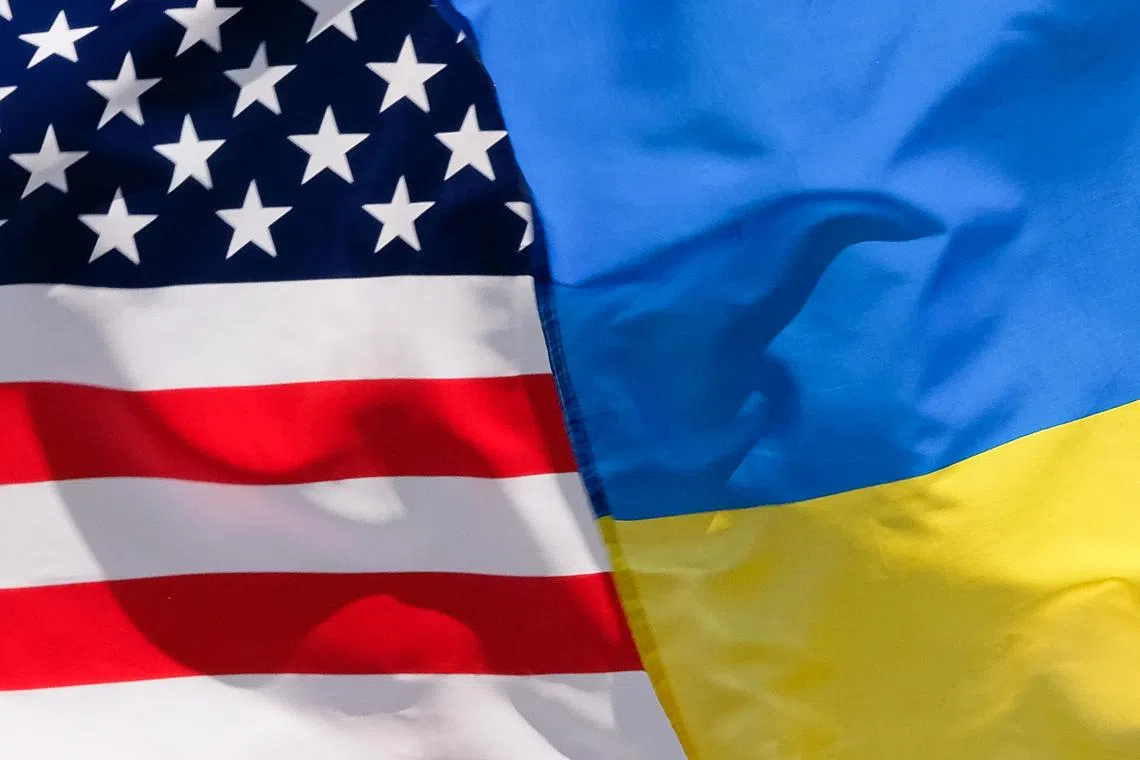 FILE PHOTO: The American and Ukrainian flags wave next to each during an Independence Day parade in Washington D.C., U.S., July 4, 2023. REUTERS/Kevin Wurm/File Photo