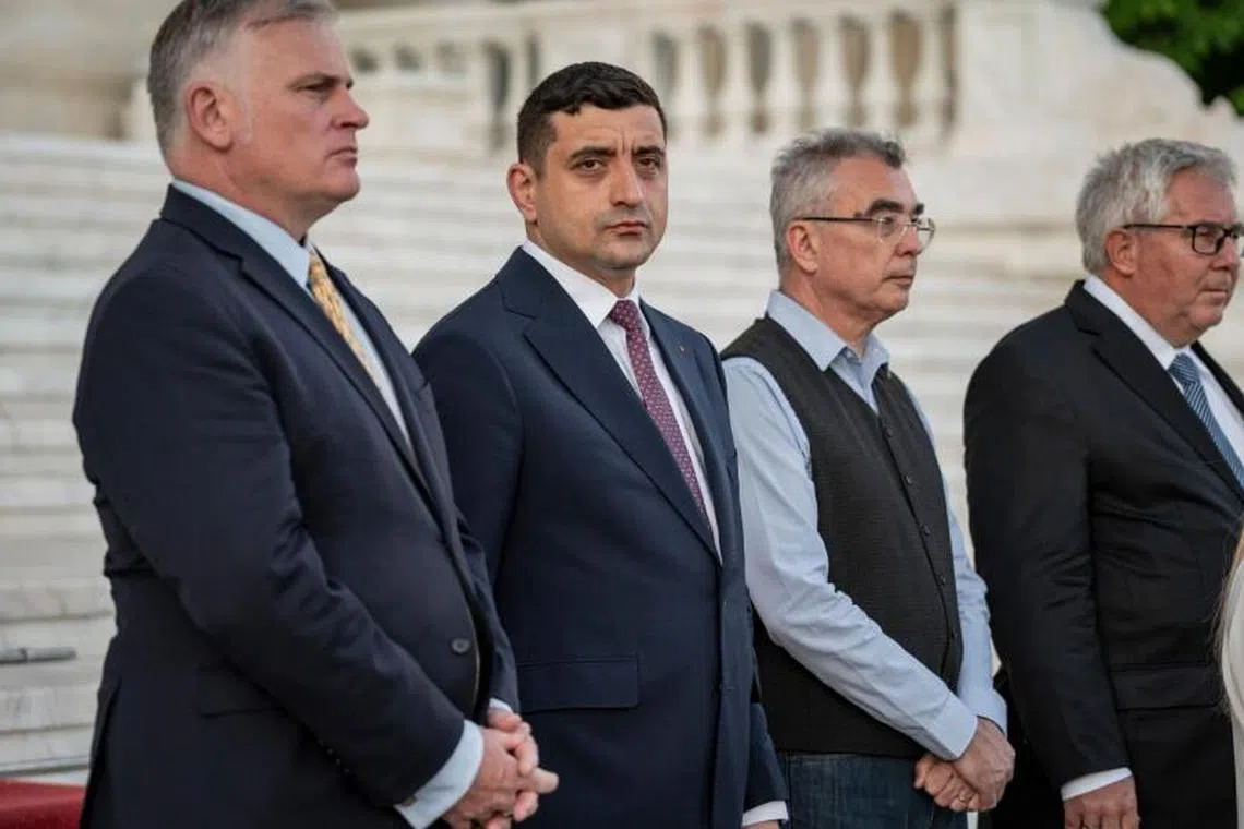 George Simion, presidential candidate and leader of the Alliance for the Union of Romanians (AUR), center, speaks during a press conference outside of the Palace of the Parliament government building in Bucharest, Romania, on Sunday, May 4, 2025. Simion, a far-right Romanian opposition leader who aligned himself with Donald Trump, secured a first-round victory in a repeat presidential election, dealing a blow to the Black Sea nation's ruling establishment amid outrage over persistent corruption and poverty. Photographer: Ioana Moldovan/Bloomberg 