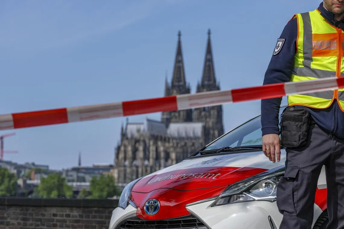 epa12154295 Employees from the public order office cordon off access to the Rhine promenade after three unexploded bombs from the Second World War were found at the Deutzer Werft in Cologne, Germany, 04 May 2025. Three World War II bombs are to be defused in Cologne. Large parts of the city centre, including the airspace, are closed for this operation. More than 20,000 people must leave their homes.  EPA-EFE/CHRISTOPHER NEUNDORF