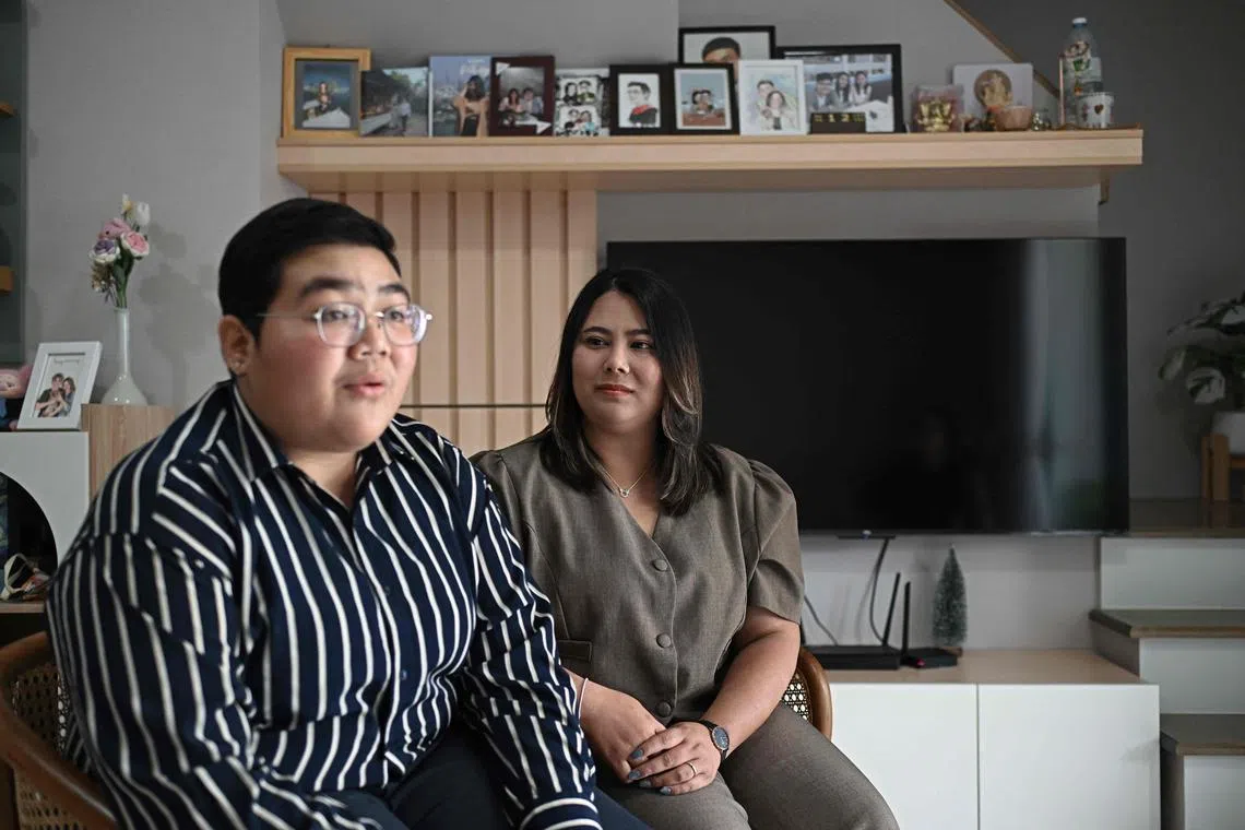 This photo taken on January 12, 2025 shows Niramon "New" Kvunkaew (R) looking at Karisa "Fah" Loywisut as they talk to AFP at their home in Bangkok. Hundreds of LGBTQ+ couples are set to marry in Thailand on January 23, as the country makes history by becoming the first country in Southeast Asia to legalise same sex marriage. (Photo by Lillian SUWANRUMPHA / AFP) / TO GO WITH Thailand-law-gender-marriage, FOCUS by Montira RUNGJIRAJITTRANON and Watsamon TRI-YASAKDA