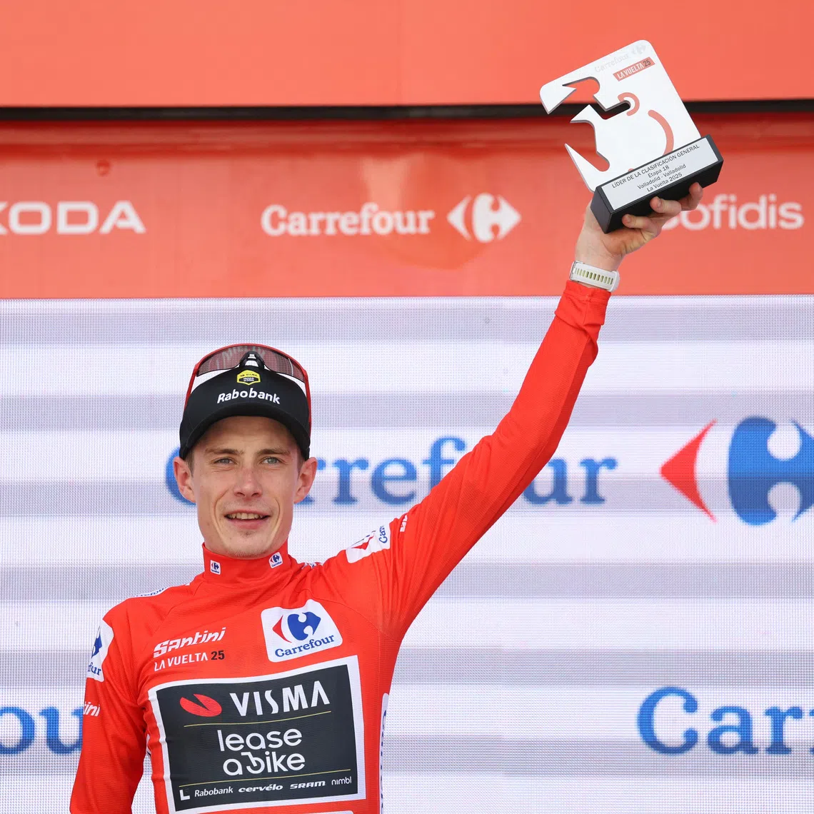 FILE PHOTO: Cycling - Vuelta a Espana - Stage 18 - Valladolid to Valladolid - Valladolid, Spain - September 11, 2025 Team Visma | Lease a Bike's Jonas Vingegaard celebrates on the podium wearing the red jersey after stage 18 REUTERS/Juan Medina/ File Photo