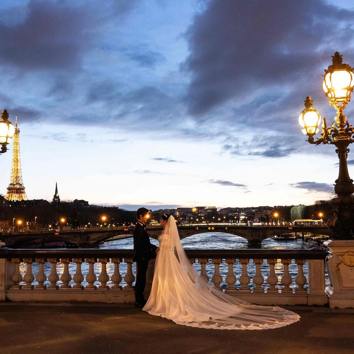 A married couple posing on the Alexander III Bridge on the river Seine in central Paris in March. Doctors in the United States say they are increasingly seeing requests for bridal surgery treatments before the big day. 