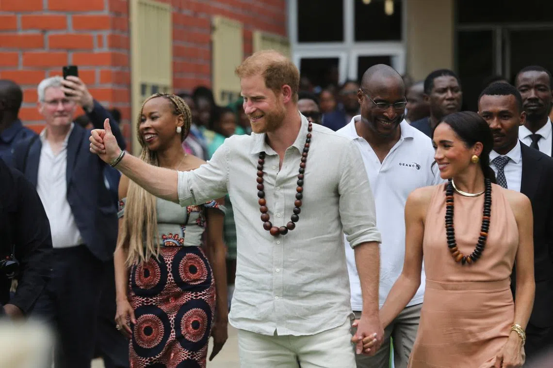 Britain's Prince Harry and his wife Meghan visiting the Lightway Academy in Abuja, Nigeria, on May 10.