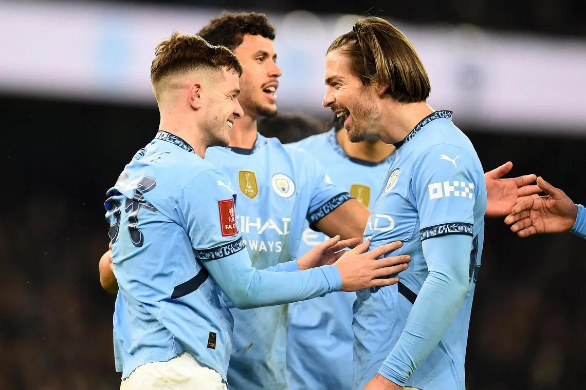 Manchester City's James McAtee celebrates scoring their eighth goal with Jack Grealish.