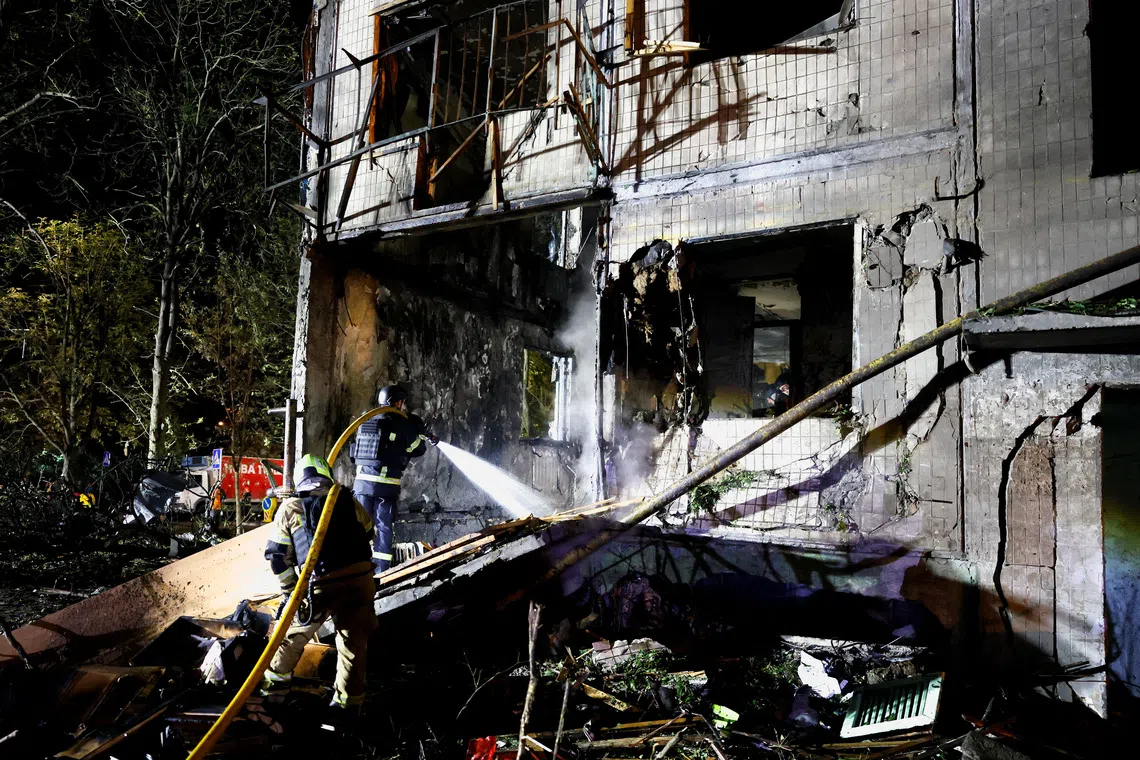 Russia pounds Kyiv with missiles, killing at least nine