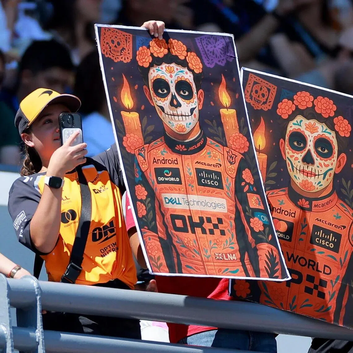 Fans are pictured holding posters depicting McLaren's Lando Norris and Oscar Piastri in traditional Day of the Dead apparel ahead of the Mexican Grand Prix.