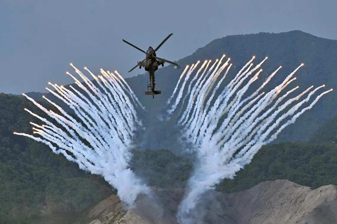 South Korea's Apache AH-64 helicopter fires flares during a South Korea-US joint military drill at Seungjin Fire Training Field in Pocheon, South Korea on June 15, 2023. 
