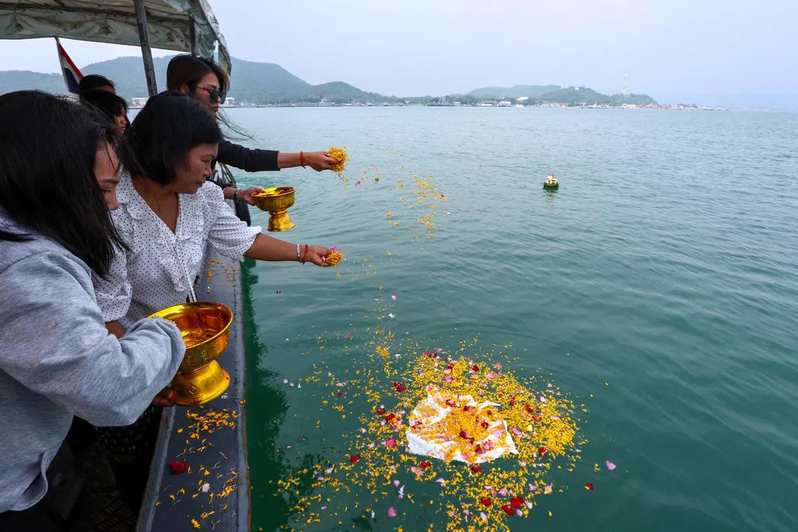 Pattanan Mumklang's mother Kanitha Koonthawee, 28, and grandmother Saowanee Donchot, 52, scatter the ashes of Pattanan Mumklang (known as "Model"), 4, who was killed in a mass shooting at a daycare centre in the town of Uthai Sawan, into the sea at the Royal Navy base in Sattahip, in Chonburi province, Thailand, October 24, 2022. The chubby-cheeked girl with a toothy smile had dreamed of seeing the sea and playing in its waves. Her grandmother had promised they would visit this year. But on Oct. 6, Model and many of her classmates were murdered at their nursery by a former police officer, in the world's deadliest killing of children in recent years. Now, several weeks later, her family traveled to the coast to scatter her ashes. "Finally, I can bring you here," Saowanee said through tears. 