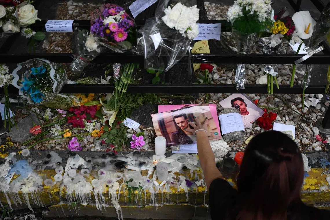 Fans pay tribute to British singer Liam Payne in front of the hotel where he died in Buenos Aires, on Oct 17.