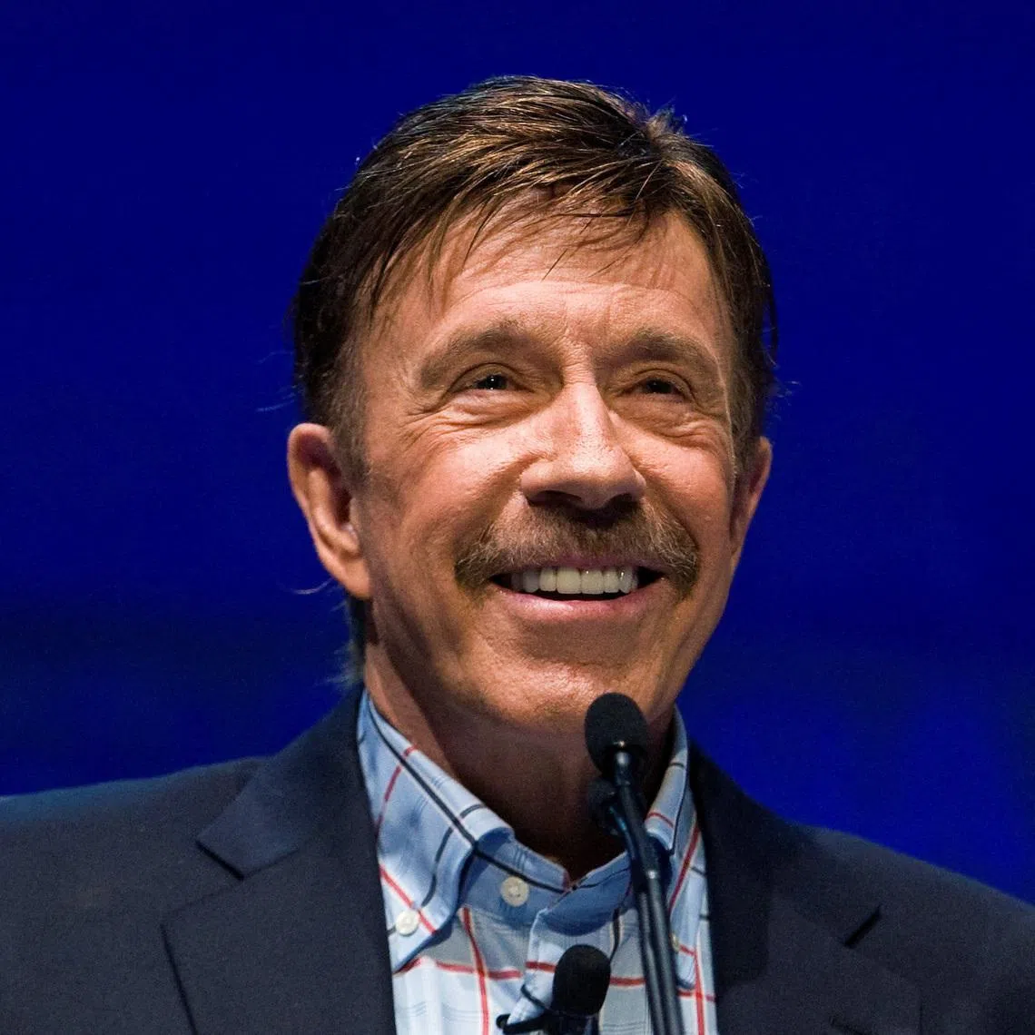 FILE PHOTO: Actor Chuck Norris speaks during the National Rifle Association's 139th annual meeting in Charlotte, North Carolina May 14, 2010. REUTERS/Chris Keane/File Photo