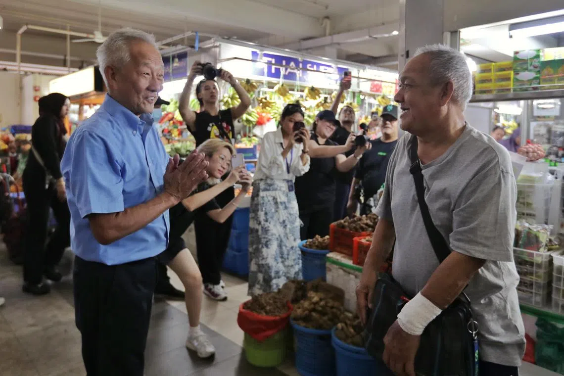 Presidential hopeful Ng Kok Song interacts with the vendors at Geylang Serai Market, on July 27, 2023.