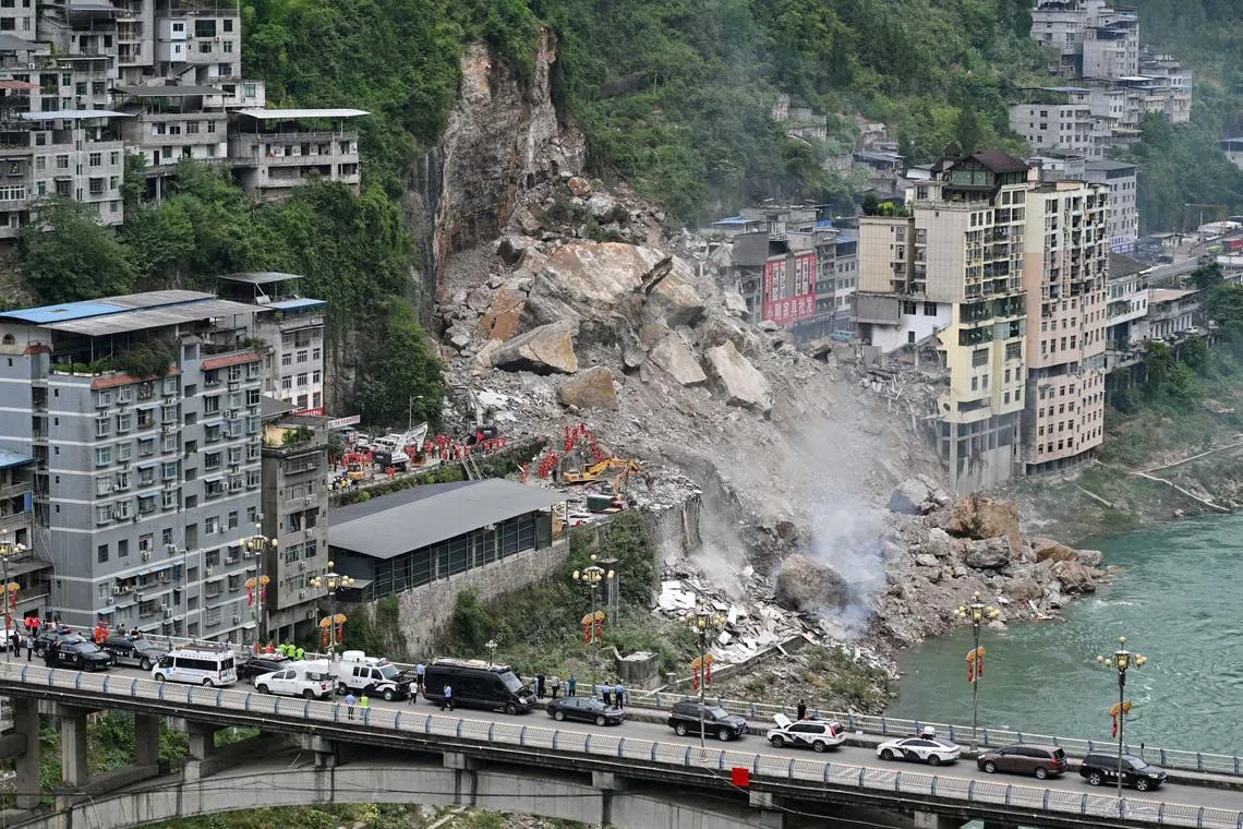 Chinese rescuers use explosives to clear boulders trapping landslide victims