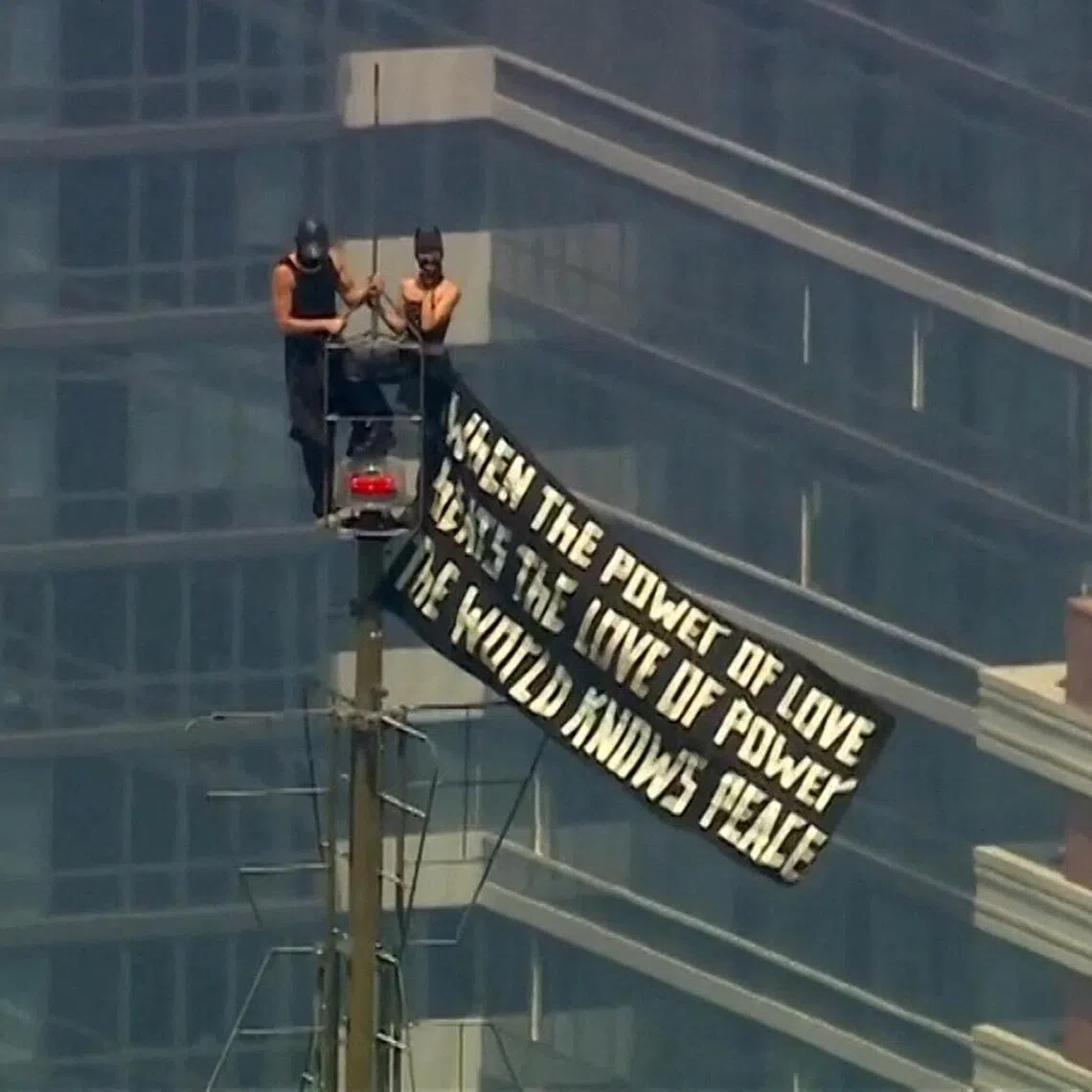 The couple unfurled a banner with a message about love and got engaged as news helicopters whirled around them.