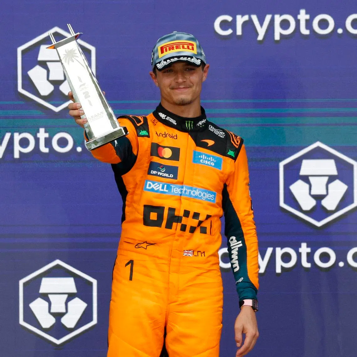 Formula One F1 - Miami Grand Prix - Miami International Autodrome, Miami, Florida, United States - May 3, 2026 McLaren's Lando Norris celebrates with a trophy on the podium after finishing second place in the Miami Grand Prix REUTERS/Marco Bello