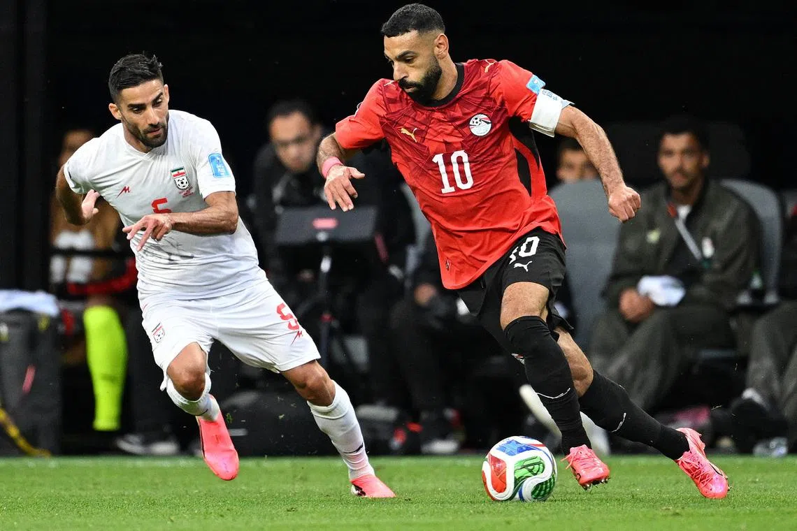 Soccer Football - FIFA World Cup 2026 - Group G - Egypt v Iran - Seattle Stadium, Seattle, Washington, U.S. - June 26, 2026 Iran's Milad Mohammadi in action with Egypt's Mohamed Salah REUTERS/Troy Wayrynen