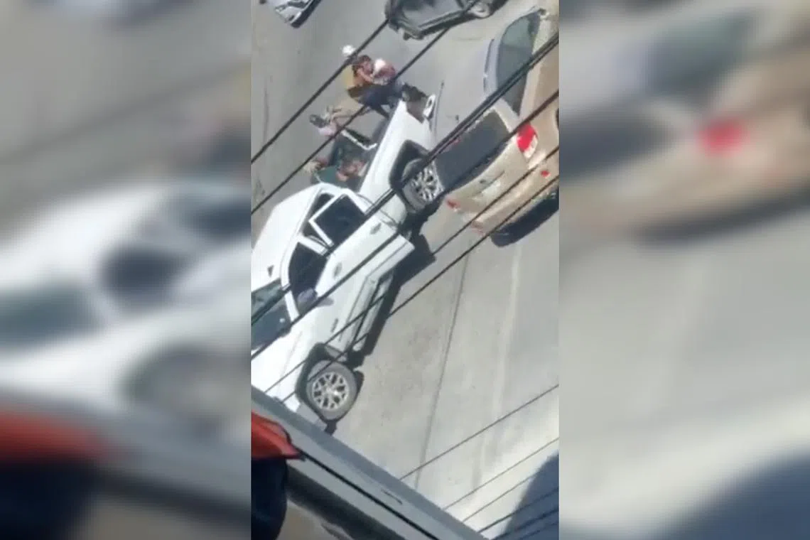A woman is carried to the back of a white pickup truck in a still image obtained from a social media video which allegedly shows the kidnapping of the four Americans.