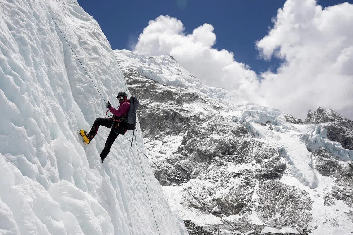 FILE PHOTO: A mountaineer holds on to the rope during an ice climbing session at Everest base camp, Nepal April 15, 2025. REUTERS/Purnima Shrestha