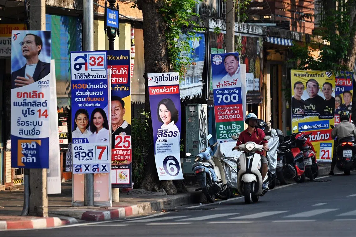 Campaign posters for the upcoming general election line a street in Bangkok on April 20, 2023. (Photo by Lillian SUWANRUMPHA / AFP)