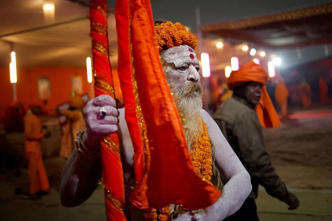 A Naga Sadhu, or a Hindu holy man, stands with his body smeared with ash during the \"Maha Kumbh Mela\", or the Great Pitcher Festival, in Prayagraj, India, January 14, 2025. REUTERS/Adnan Abidi