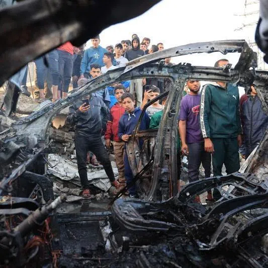 Palestinians inspect a vehicle targeted by an Israeli strike in Maghazi camp for Palestinian refugees in the central Gaza Strip on April 4, 2026.