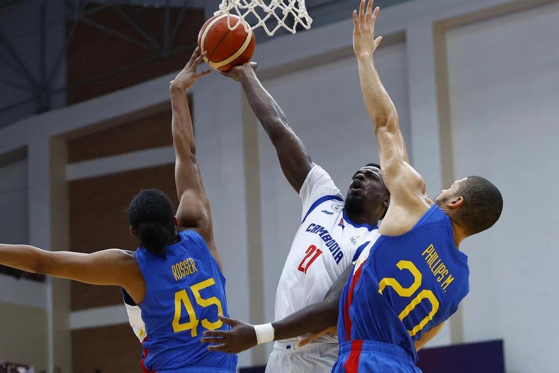 Southeast Asian Games - Basketball - Cambodia v Philippines - Final - Morodok Techo Elephant Hall 2, Phnom Penh, Cambodia - May 16, 2023
Cambodia's Peterson Brandon Jerome in action with Philippines' Brandon Ganuelas Rosser and Phillips Michael REUTERS/Kim Kyung-Hoon