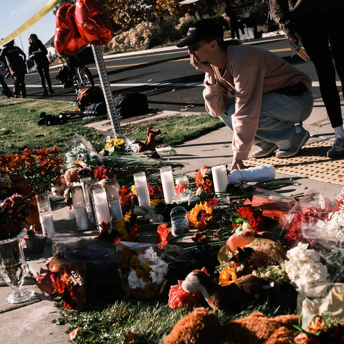 A woman reacts at a makeshift memorial outside of Silver Rail Elementary School in Bend, Oregon, on Oct 16.