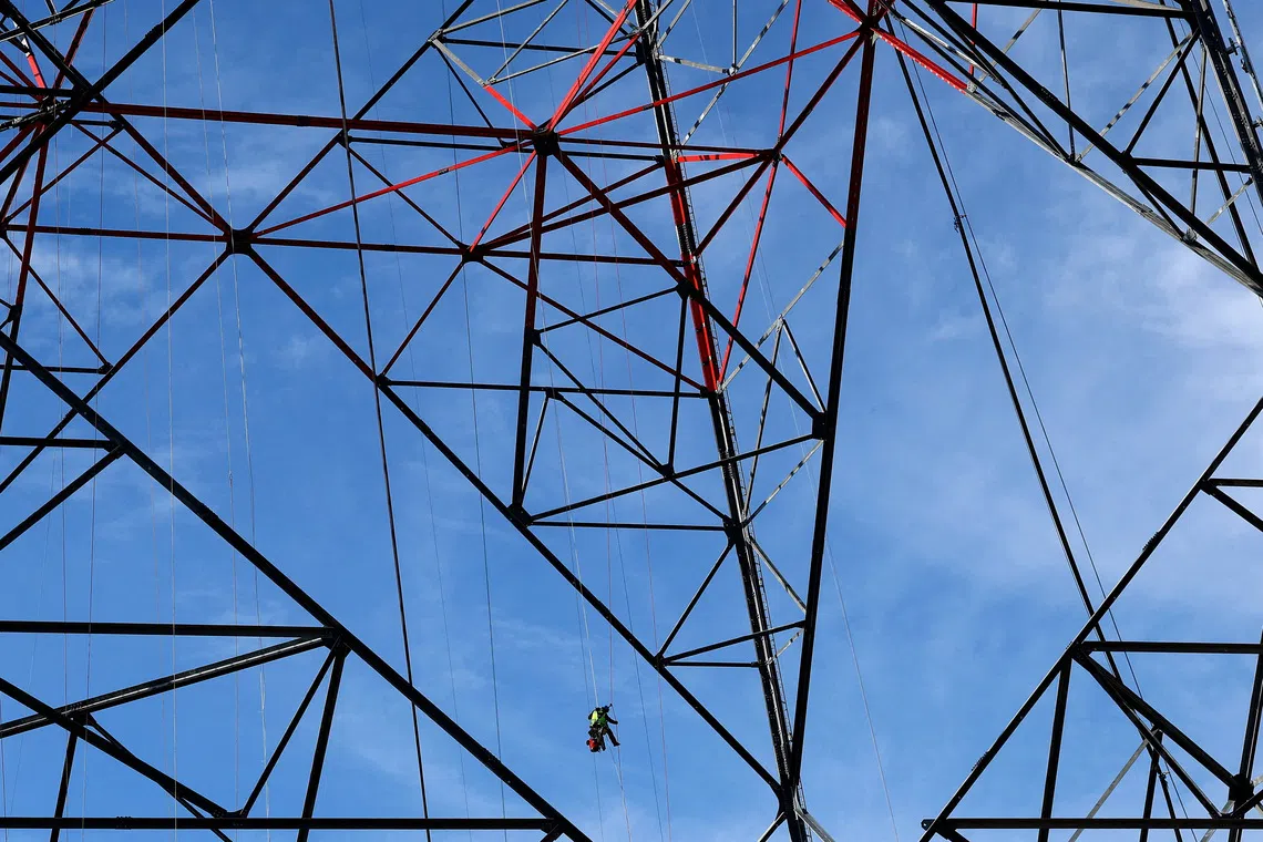A worker ropes down from a 365-metre wind turbine built by German technology group Gicon in a wind park area near Schipkau, Germany, October 1, 2026. REUTERS/Lisi Niesner TPX IMAGES OF THE DAY