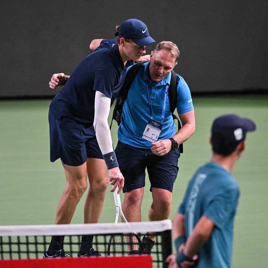 Italy's world No. 2 Jannik Sinner is helped by a medical trainer during his men's singles match against Netherlands' Tallon Griekspoor at the Shanghai Masters tennis on Oct 5, 2025. He was one of seven retirements or walkovers at the tournament, while at the China Open, five of 12 matches ended prematurely during a single day.