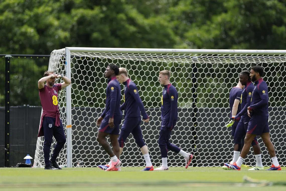 England manager Gareth Southgate looks on at his players during a training session.