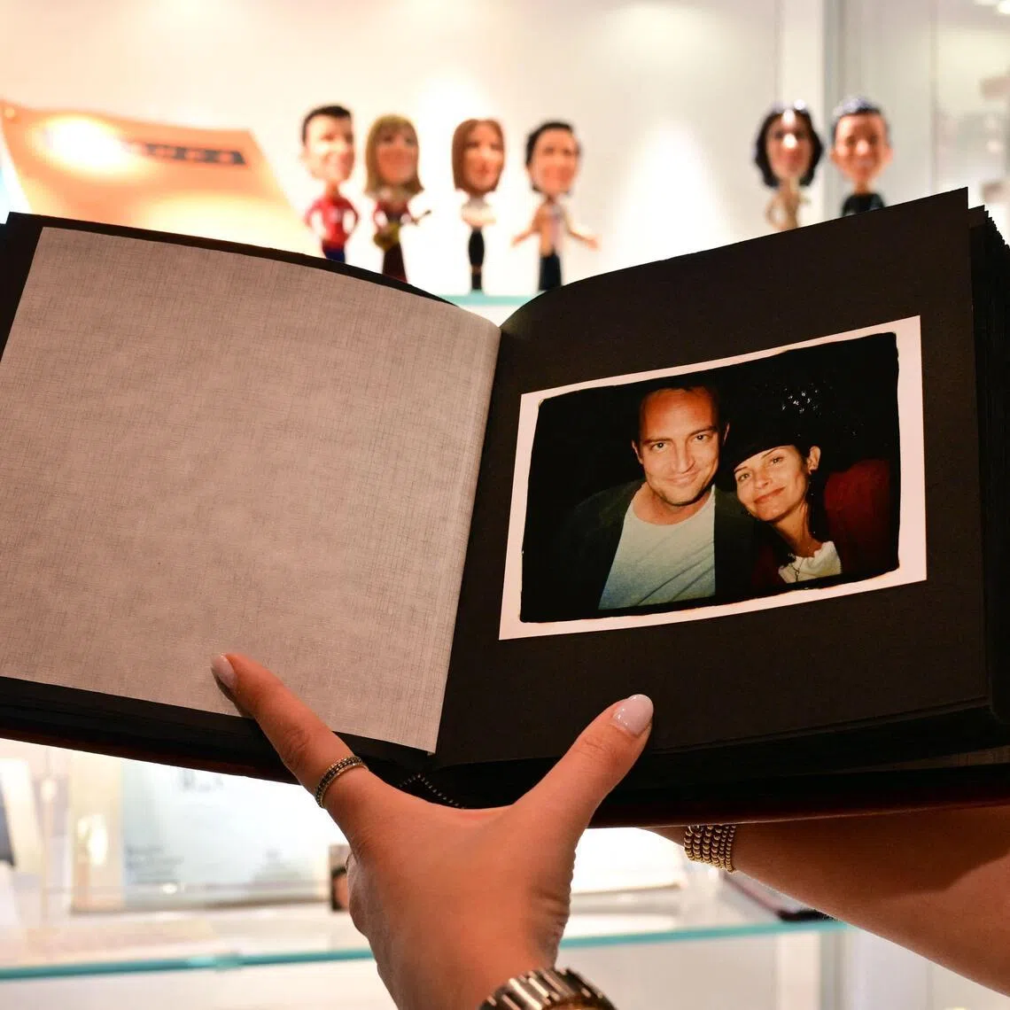 A photo album given by actress Jennifer Aniston to fellow Friends cast members Matthew Perry and Courteney Cox, is displayed ahead of The Matthew Perry Estate Auction at Heritage Auctions in Beverly Hills, California, on May 19, 2026. 