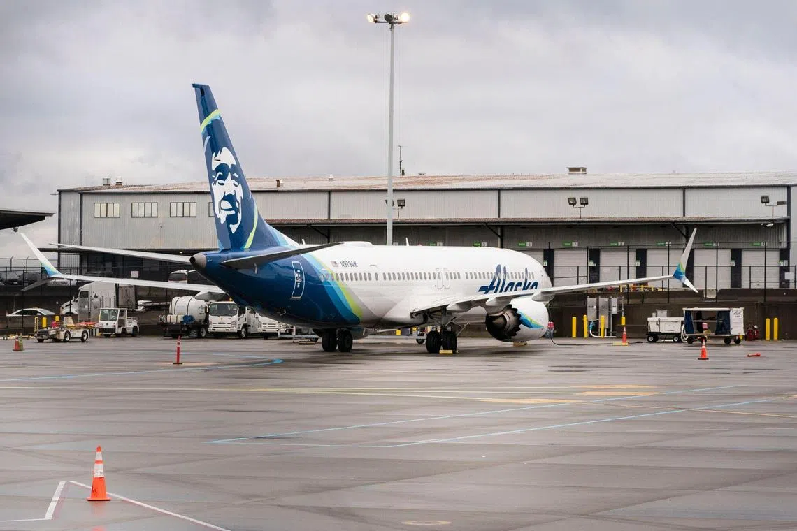 An Alaska Airlines Boeing 737 Max-9 aircraft at Seattle-Tacoma International Airport in Seattle on Jan 6. Alaska Airlines will ground its entire fleet of Boeing Co. 737 Max-9 aircraft after a fuselage section in the rear part of the brand-new jet blew out shortly after takeoff. 