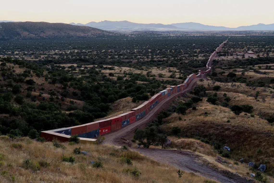 A view of shipping containers from the border wall on the frontier with Mexico in Cochise County, Arizona, U.S. November 6, 2022.  