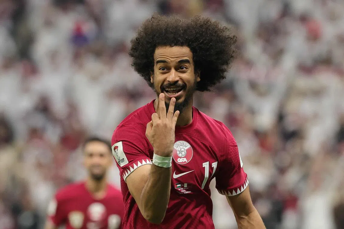 Qatar forward Akram Afif celebrates after scoring his third goal from a penalty shot, during the Asian Cup final against Jordan.
