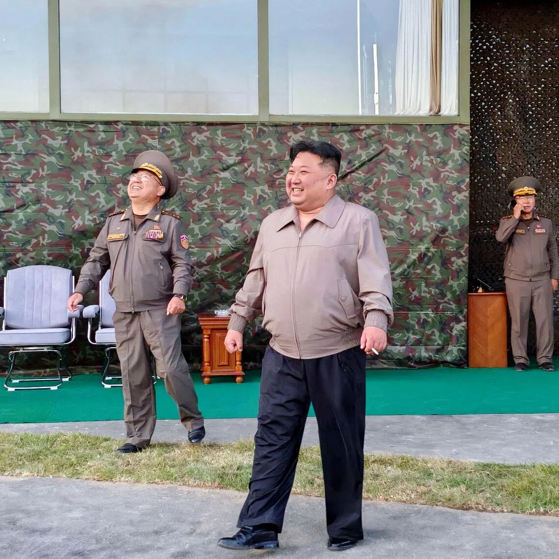 North Korean leader Kim Jong Un (centre), accompanied by his daughter Kim Ju Ae (right), oversees the firing of an intermediate-range missile during a drill on Oct 3.