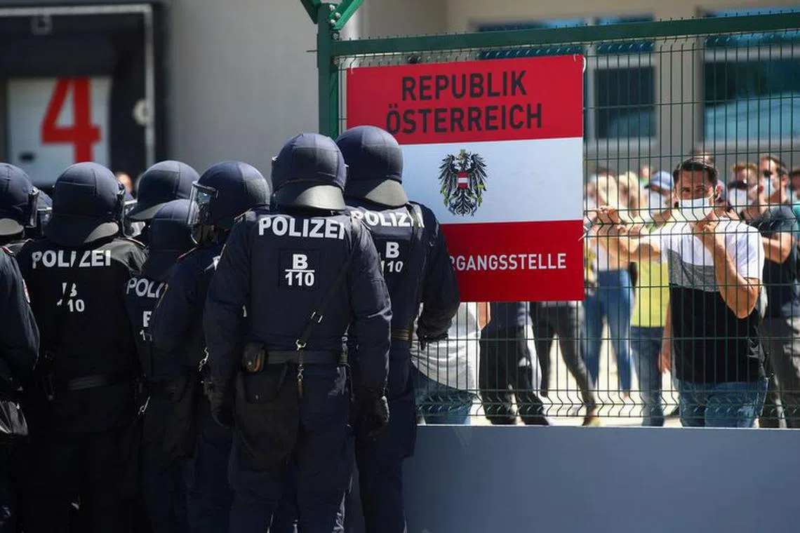 FILE PHOTO: Austrian police officers attend an exercise to prevent migrants from crossing the Austrian border from Hungary in Nickelsdorf, Austria, July 2, 2020. REUTERS/Lisi Niesner/File Photo