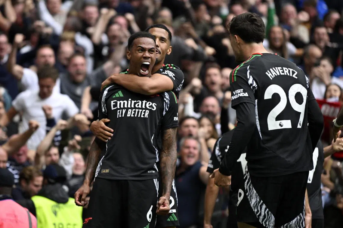 Arsenal's Gabriel Magalhaes celebrates scoring with William Saliba and Kai Havertz.