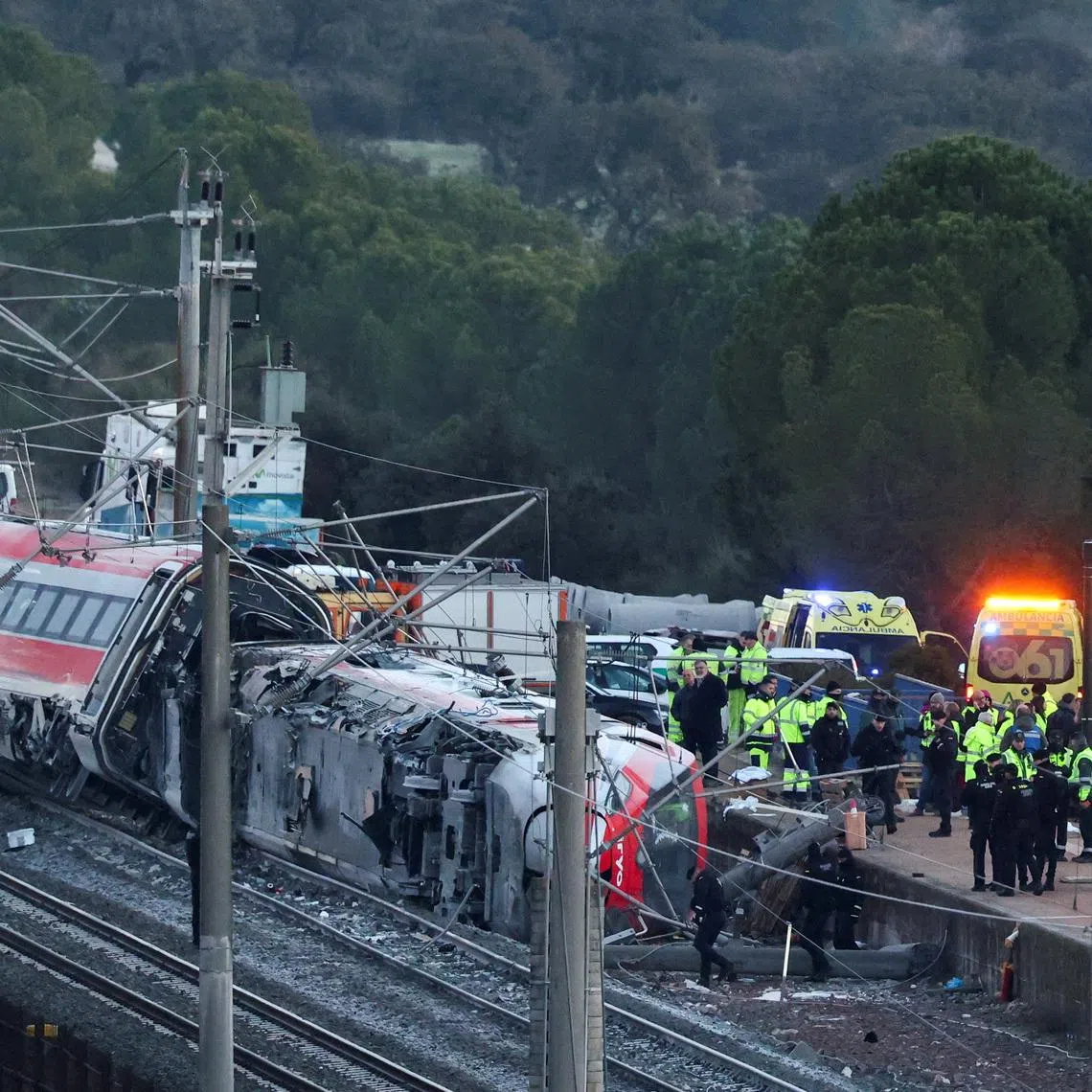 Emergency personnel work next to one of the trains involved in the accident, near Adamuz, in Cordoba, Spain, January 19. REUTERS/Susana Vera