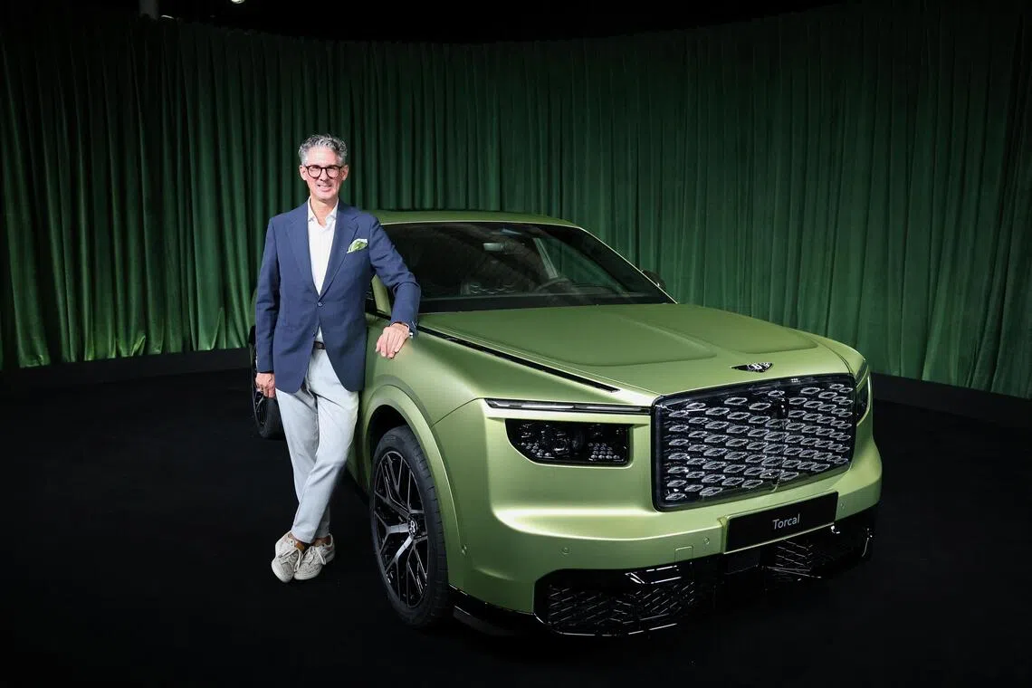Chairman and CEO of Bentley Motors, Frank-Steffen Walliser, posing beside the Torcal, Bentley’s first fully-electric model, during a launch event in London, Britain, on Sept 23.