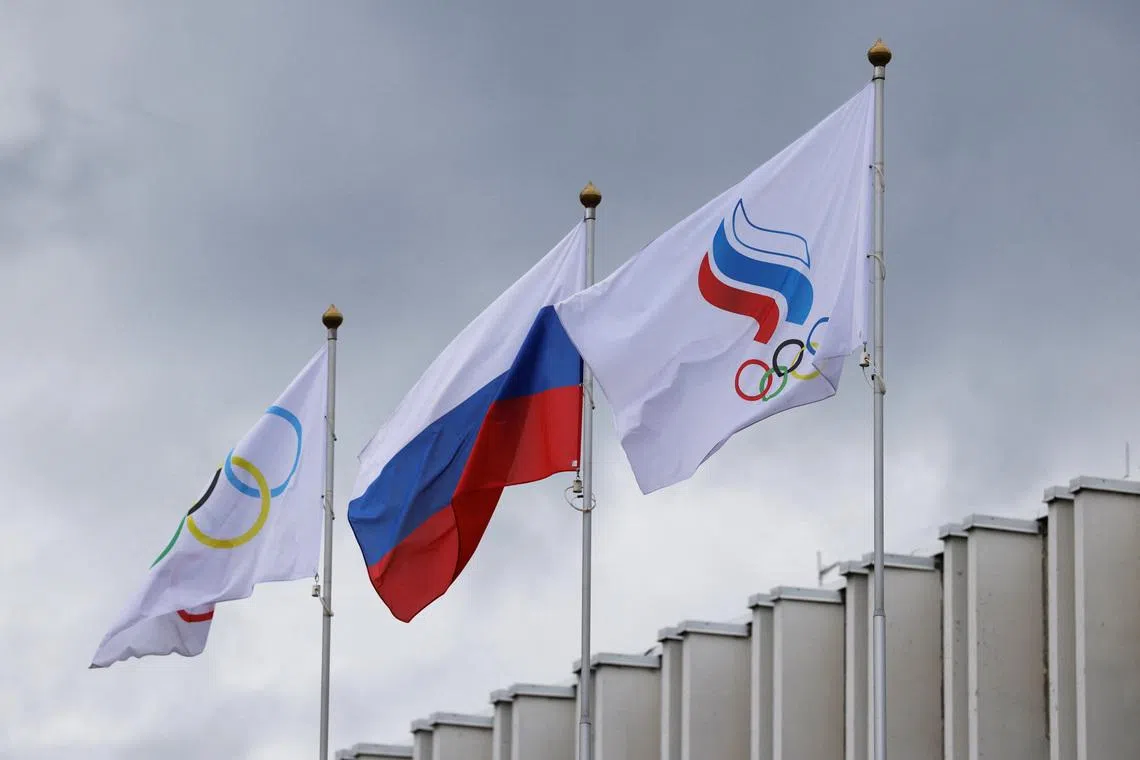 The Russian flag, the Olympic flag and the flag of the Russian Olympic Committee fly at the Committee's headquarters in Moscow, Russia July 8, 2026. REUTERS/Ramil Sitdikov