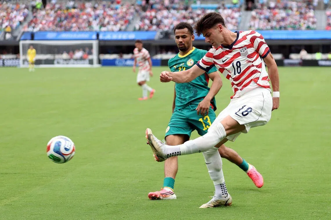 The United States' Max Arfsten crossing the ball as Senegal's Iliman Ndiaye looks on during a friendly on May 31. 