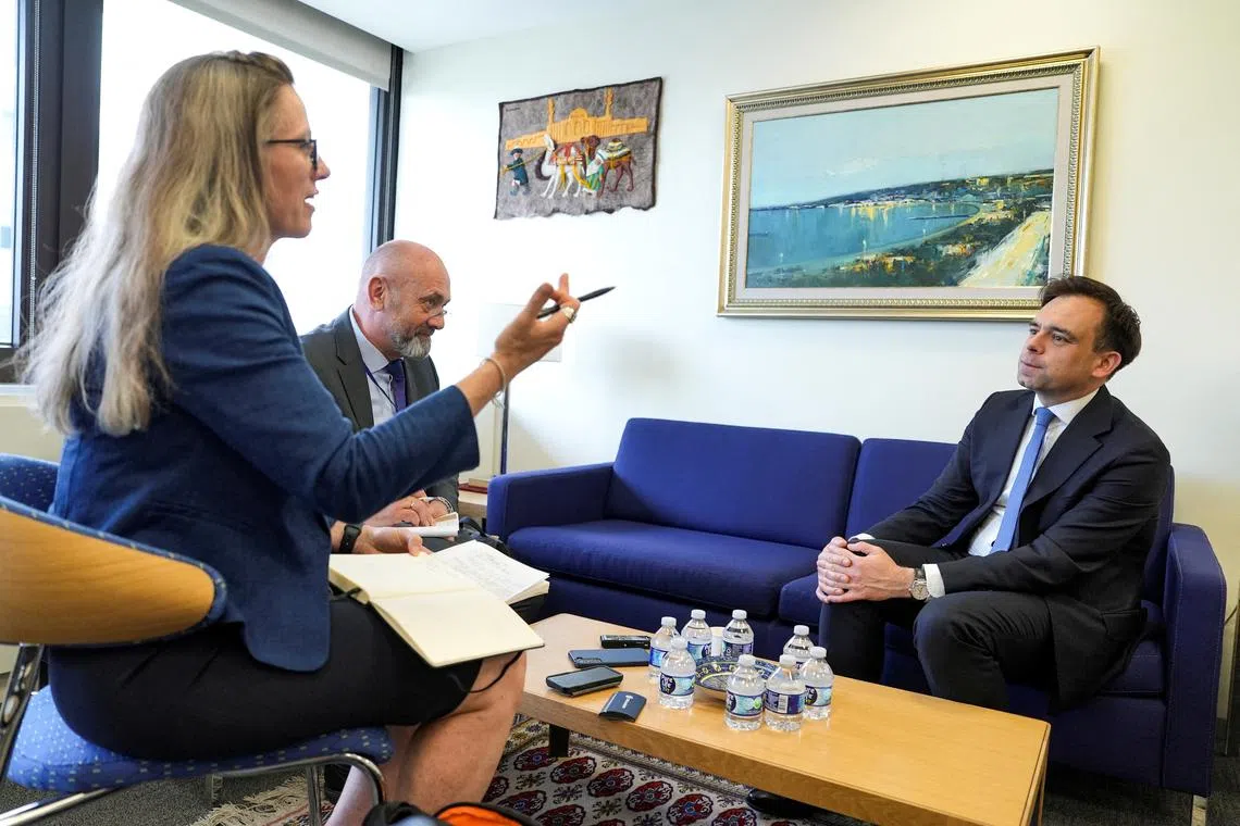FILE PHOTO: Polish Finance Minister Andrzej Domanski (on right) looks on during a Reuters interview at the 2025 annual IMF and World Bank spring meetings in Washington, D.C., U.S., April 24, 2025. REUTERS/Cedeno/File Photo