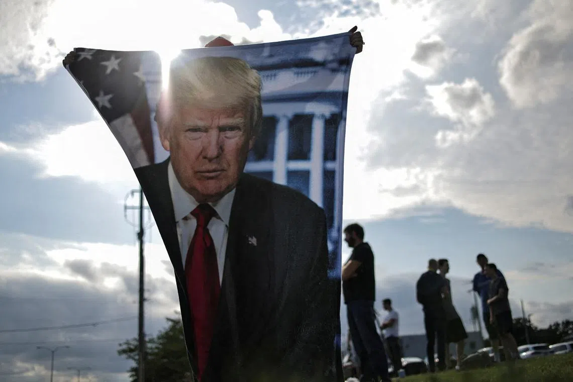 Supporters of Republican presidential candidate and former U.S. President Donald Trump wait for his arrival in Milwaukee, Wisconsin, U.S., July 14, 2024 a day after he survived an assassination attempt at a rally in Butler, Pennsylvania.  REUTERS/Carlos Barria