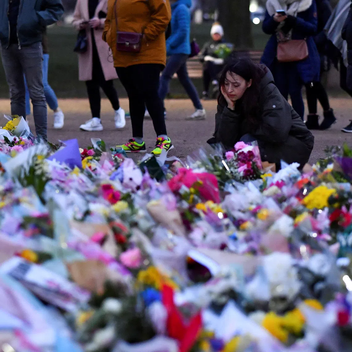 FILE PHOTO: A woman looks on at the memorial site at the Clapham Common Bandstand, following the kidnap and murder of Sarah Everard, in London, Britain, March 16, 2021. REUTERS/Dylan Martinez/File Photo